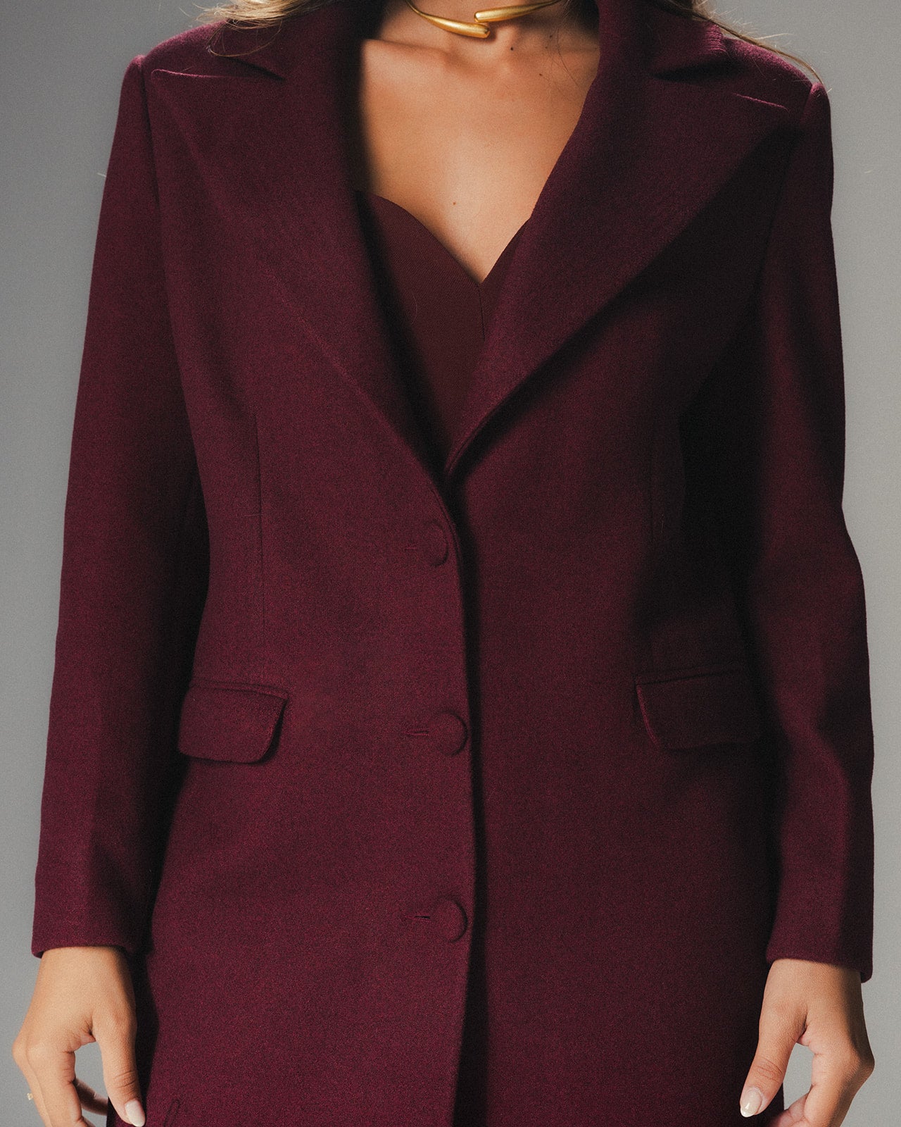Close view of MYSHA Bordeaux burgundy wool coat with matching detachable fur collar.