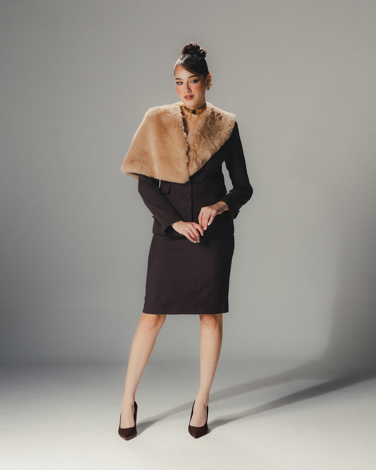 Model wearing the MYSHA Espresso brown blazer with fur collar and matching tailored skirt for a complete feminine suit look