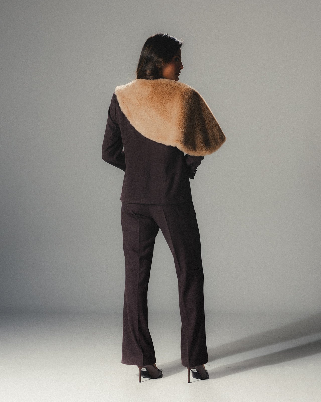 Back view of model wearing the MYSHA Espresso brown blazer and matching tailored pants