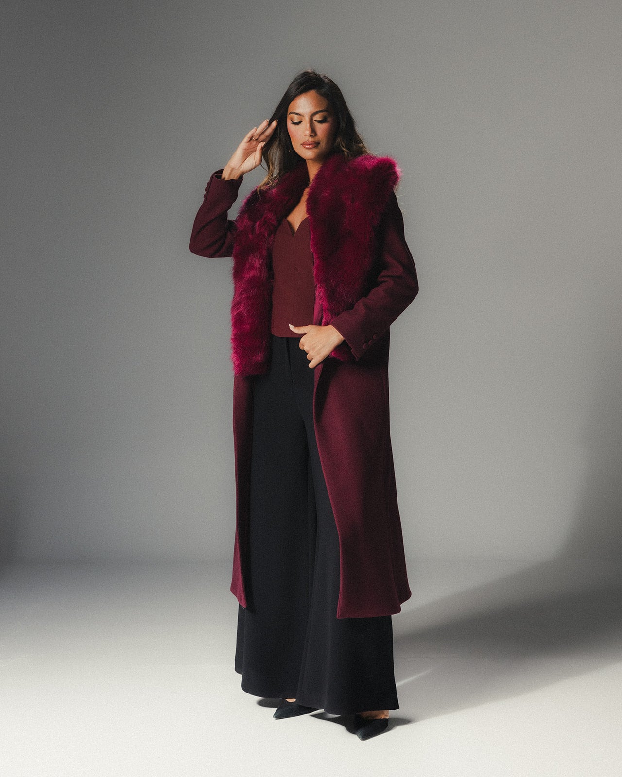Front view of MYSHA Bordeaux burgundy wool coat with matching detachable fur collar.
