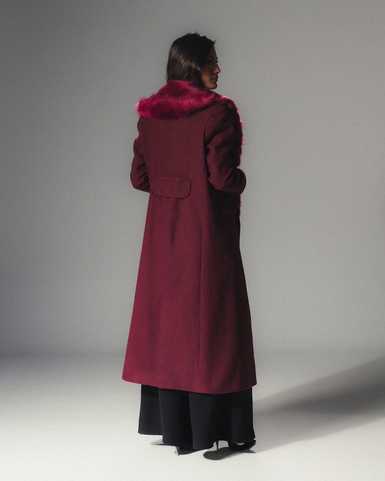 Back view of MYSHA Bordeaux burgundy wool coat with matching detachable fur collar.