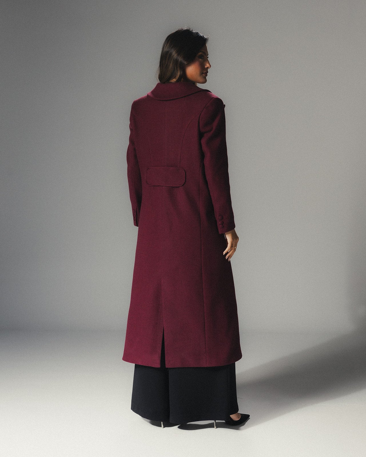 Back view of MYSHA Bordeaux burgundy wool coat with matching detachable fur collar.