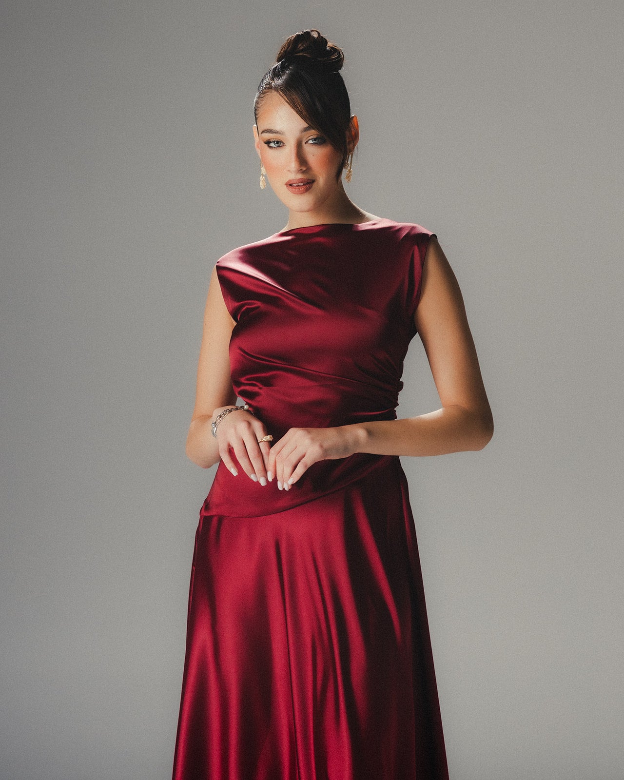 Close-up of the luminous ruby red Satin Armani fabric and high-neckline on a MYSHA luxury dress.